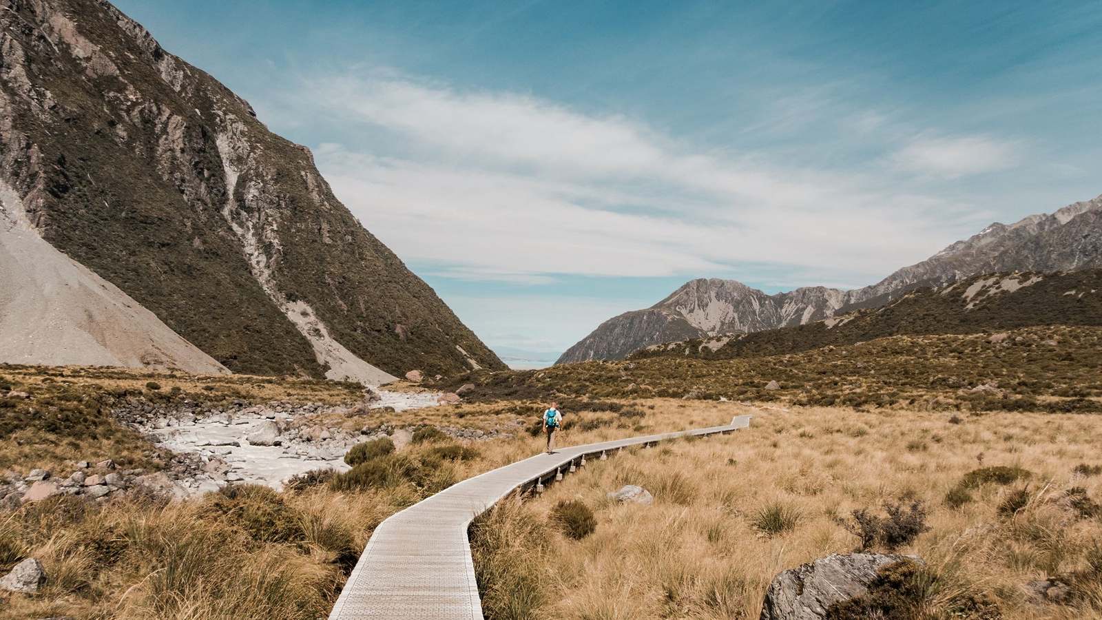 A boardwalk across tussock in a New Zealand alpine valley