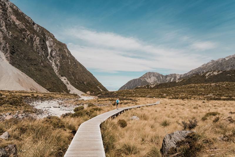 A boardwalk across tussock in a New Zealand alpine valley