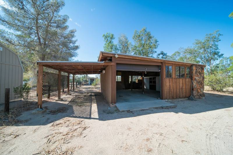 A timber carport beside a timber garage