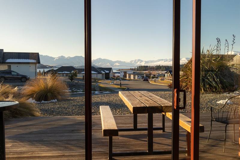 A timber deck looking out to the Southern Alps at Lake Tekapo
